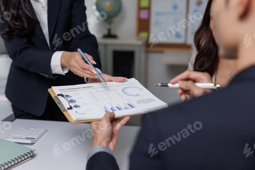Preview: Business colleagues reviewing financial loan comparison calculator document