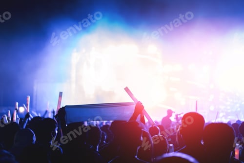Preview: Crowd of concert stage lights and people fan audience silhouette raising hands or glow stick holding