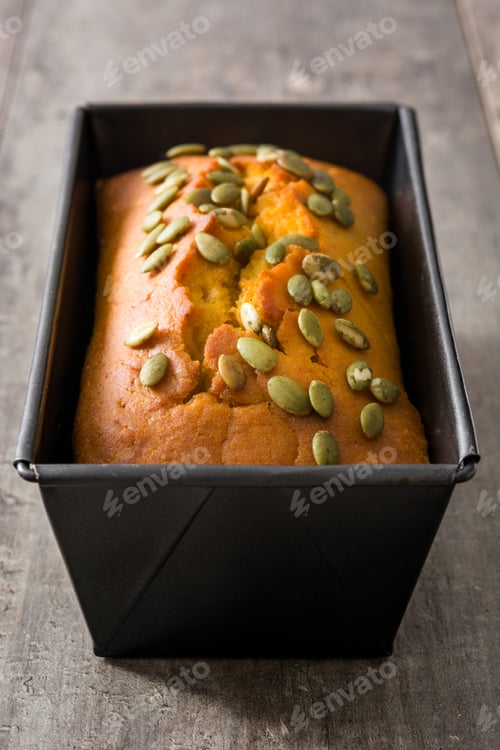 Preview: Freshly baked pumpkin bread with pumpkin seeds in a loaf pan