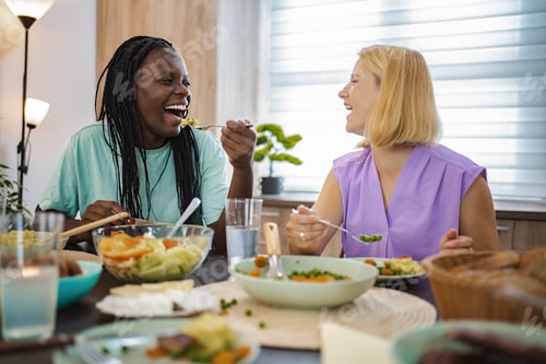 Preview: Friends enjoy a joyful meal together in a cozy dining space