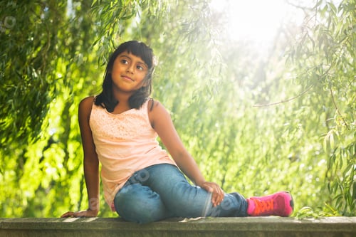Preview: Portrait of girl (6-7) sitting in park