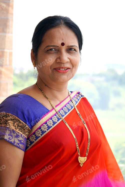 Preview: Portrait of happy traditionally dressed Indian woman