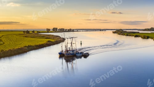 Preview: Aerial view of river with ship at sunset