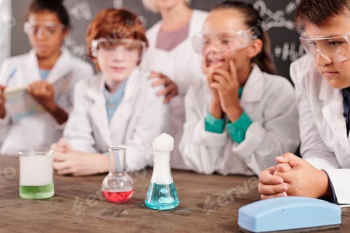 Preview: Three glass tubes with chemical compounds standing on teacher desk in lab