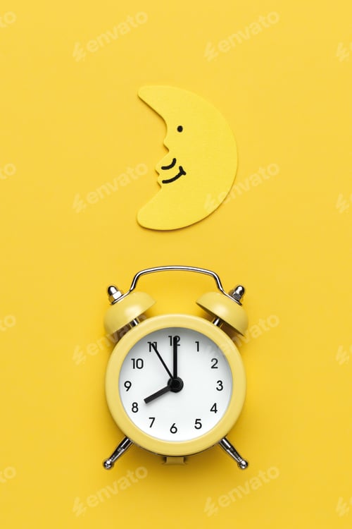 Preview: Yellow round alarm clock and moon on the yellow background.