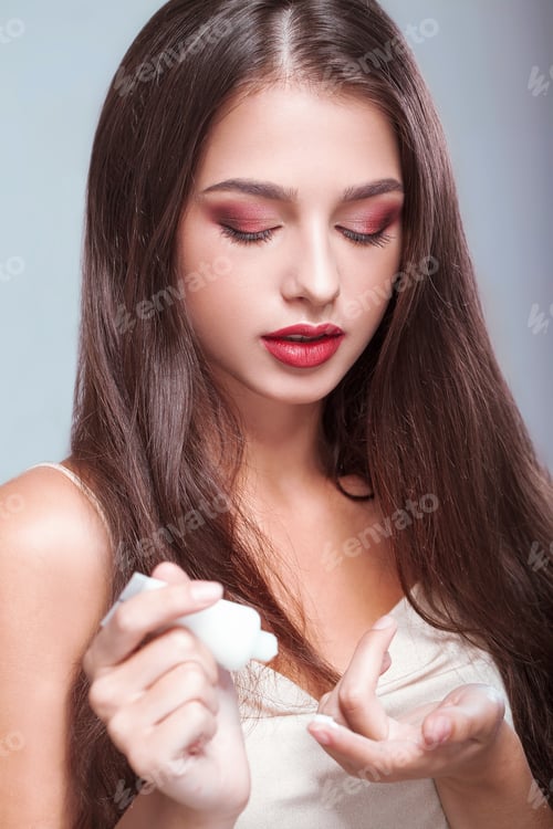 Preview: Beautiful Woman Applying Cream in a Home Setting