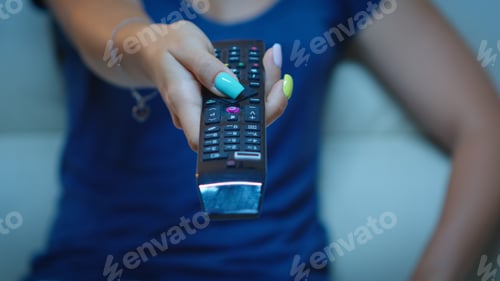 Preview: Close up of hand changing TV channels
