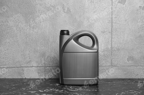 Preview: Motor oil in canister on black table near grey wall