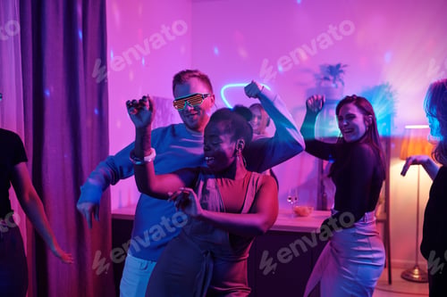 Preview: Group of young cheerful intercultural friends in casualwear dancing excitedly
