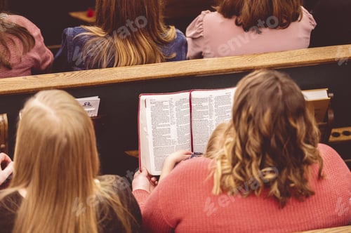 Preview: Group of people reading the bible in the church under the lights
