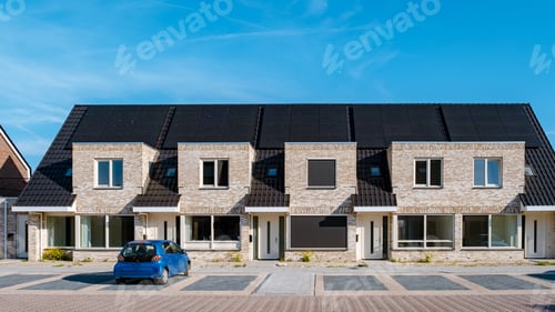 Aperçu: Newly build houses with solar panels attached on roof against a sunny sky Close up of solar pannel
