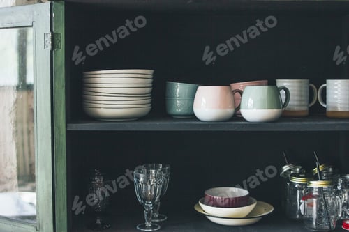 Preview: Vintage wooden green sideboard with dishes on rustic kitchen
