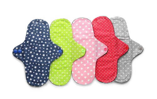 Preview: Many cloth menstrual pads on white background, top view. Reusable female hygiene product