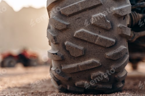 Preview: Big ATV wheel up close in the desert. An important part of an ATV