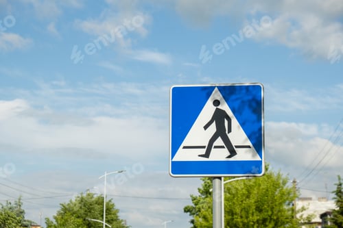Preview: Vertical signage of crosswalk over cloudy sky, road sign pedestrian crossing. Attention road sign