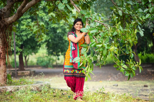 Preview: Beautiful girl between nature full of branches of tree.