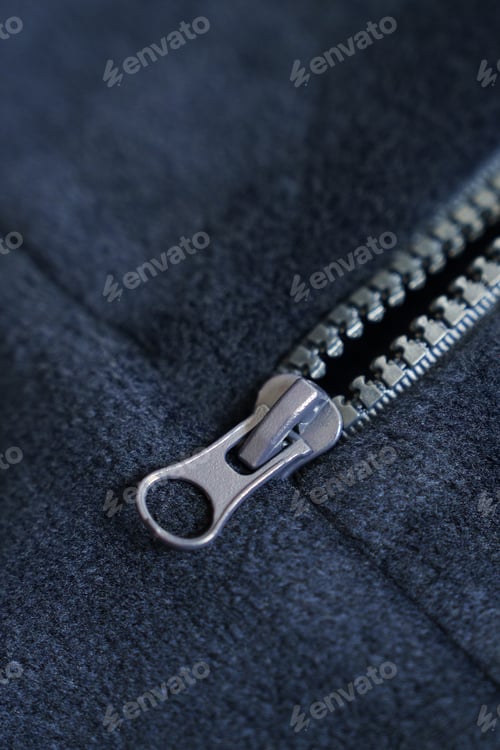 Preview: Metal zipper on blue fleece fabric. Macro photography of clothing.