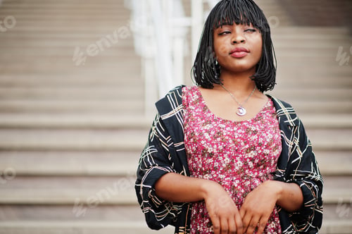 Preview: Portrait of beautiful african american woman standing on stairs.