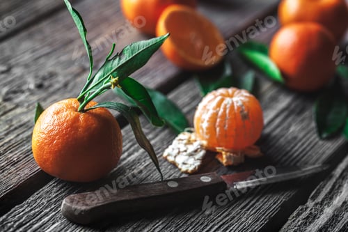 Preview: tangerines with a knife on a wooden background. Healthy food. Fruit