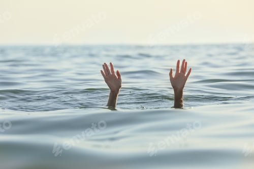 Preview: Drowning woman reaching for help in sea