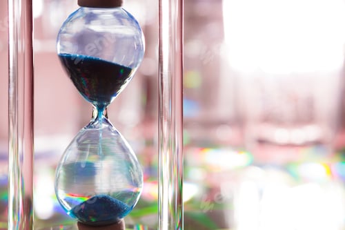 Preview: Blue hourglass on gray background close up