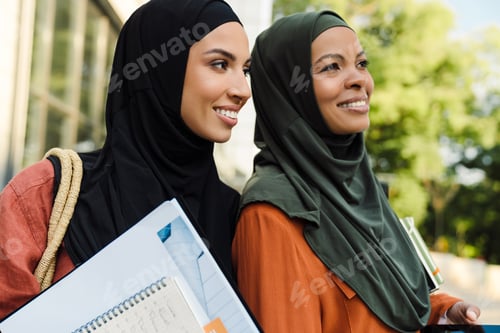 Preview: Multiracial muslim women smiling together while standing outdoors
