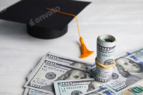 Preview: Dollar banknotes and student graduation hat on white wooden background. Tuition fees concept