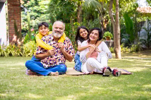 Preview: Happy Indian grandparents and children enjoying outdoor bonding time in park