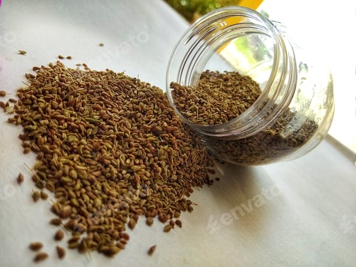 Preview: Jar of Seeds Spilling onto a White Surface