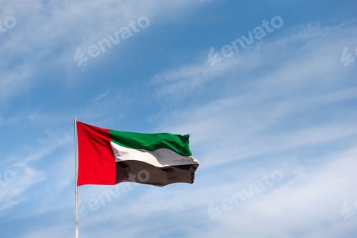 Preview: UAE flag waving in the sky during bright sunny day. UAE National day. UAE flag day. Space for text.