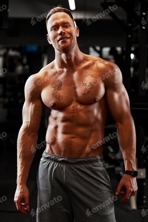 Preview: Closeup portrait of a muscular man workout with barbell at gym. Brutal bodybuilder athletic man with