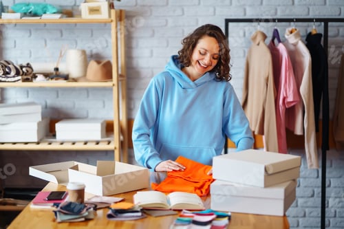 Preview: Close-up of preparing a parcel on the table. Woman online store, small business owner, entrepreneur.