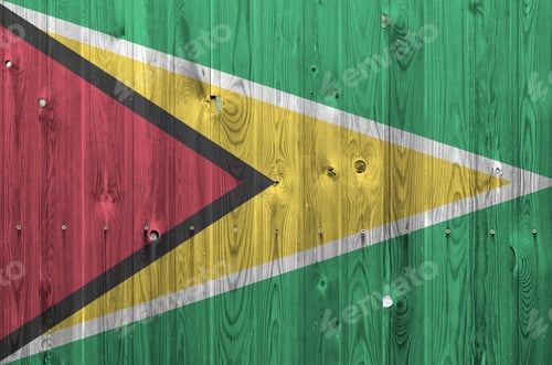 Preview: Guyana flag depicted in bright paint colors on old wooden wall close up