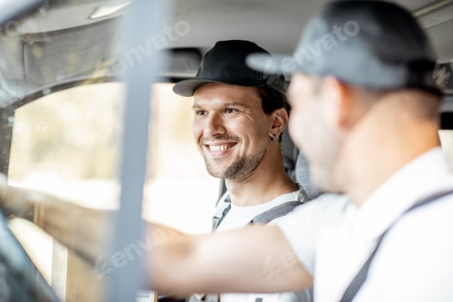 Preview: Delivery company employees driving a cargo vehicle