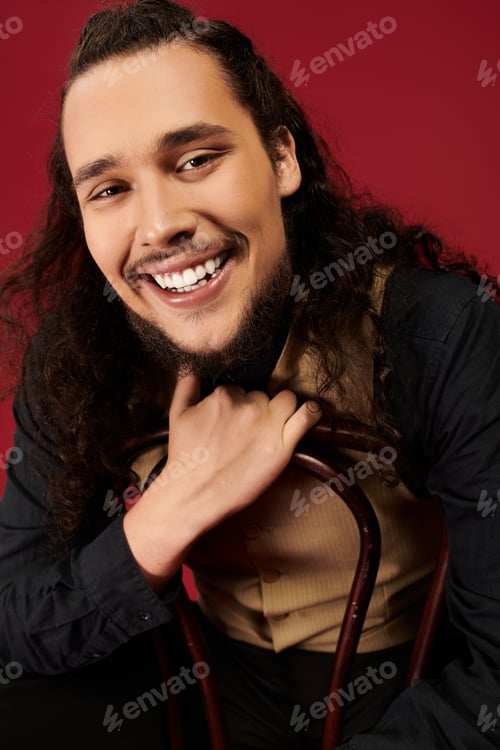 Preview: Captivating smile of a handsome young bearded man in a stylish setting