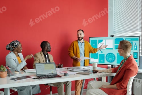 Preview: Diverse Business Team Listening to Presentation on Meeting