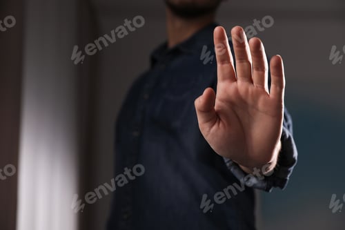 Preview: Man offering helping hand on blurred background, closeup. Space for text
