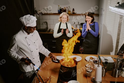Preview: Middle Aged Man Teaching Cooking Class Demonstrating Flambe Technique