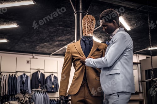 Preview: Handsome elegantly dressed African-American man in a classic menswear store