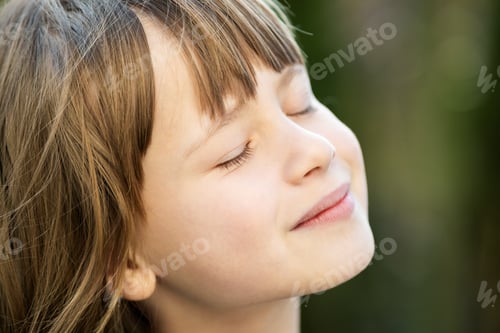 Preview: Portrait of young pretty child girl with long hair enjoying warm sunny day in summer
