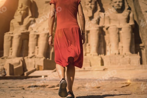 Preview: A young tourist in a red dress entering the Abu Simbel Temple in southern Egypt