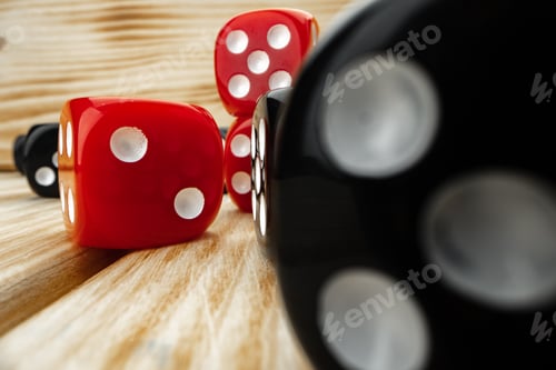Preview: Red and black dice cubes on wooden background