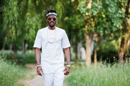 Preview: Portrait of stylish and rich black african american man on white clothes, sunglasses and hat