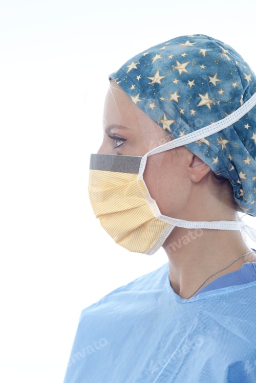 Preview: Surgeon wearing surgical cap and mask looking away