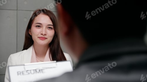 Preview: Woman job seeker in a suit, She being interviewed for a job.