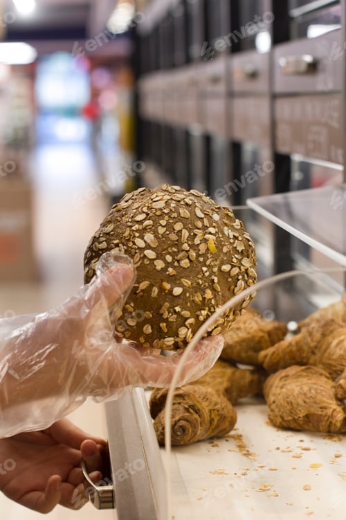 Preview: Female Hand Choosing Bread In The Market