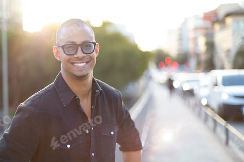 Preview: Smiling casual cool man standing in the city