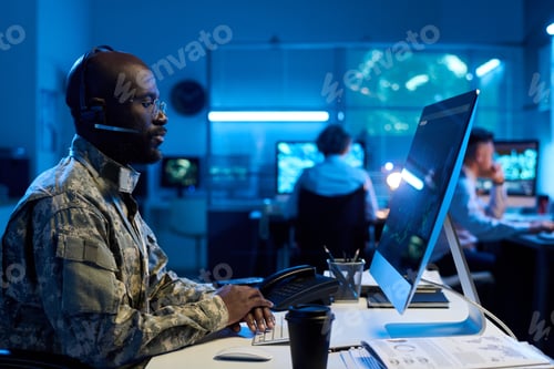 Preview: Man Working at Computer With Teammates in Office