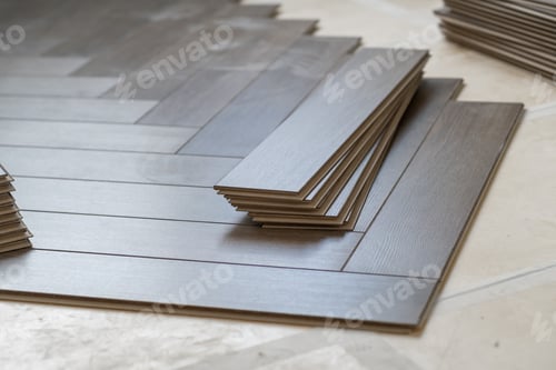 Preview: Worker installing laminate flooring in a residential apartment. Tools, planks