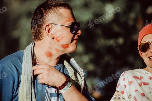 Man Smiles with Red Lipstick Marks on Face